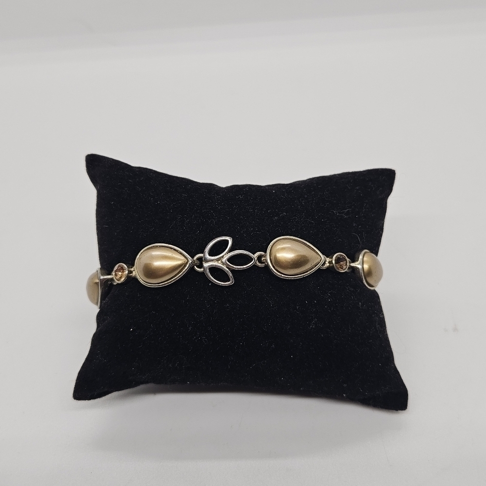 gold tone teardrop link bracelet with orangey rhinestones